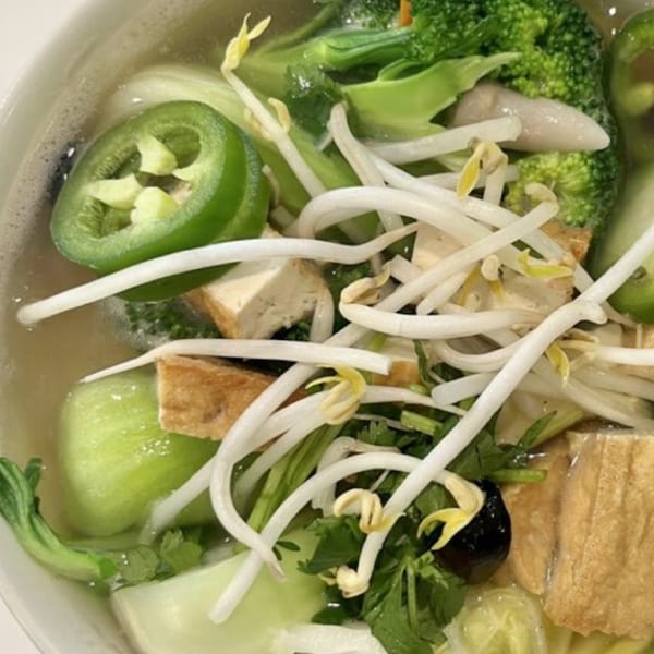 Close-up of Pho Viet Cali's vegetarian pho with tofu, broccoli, bok choy, bean sprouts, and jalapeños.
